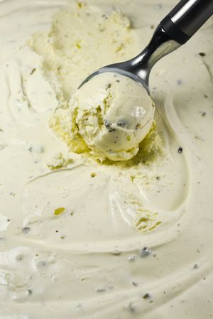Close up of scoop creating ball of pistachio ice cream
