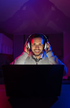 Man listening cheerfully to music with headphones.