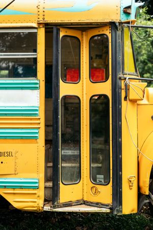 Vintage yellow school bus with the door partially open