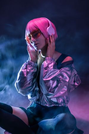 Young Asian woman listening music in headphones