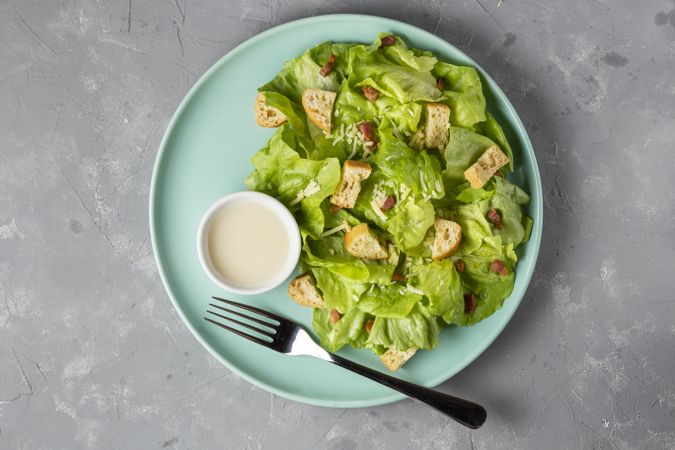 Caesar salad with croutons and bacon.