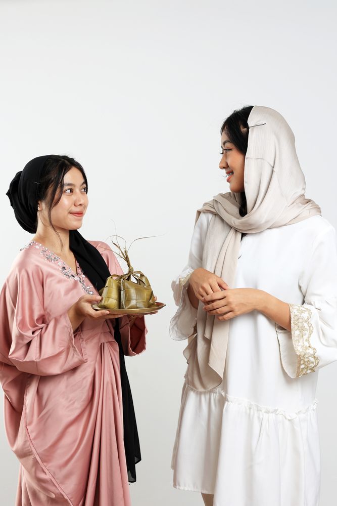 Two Friends Celebration Idul Fitri Or Eid Mubarak with Ketupat