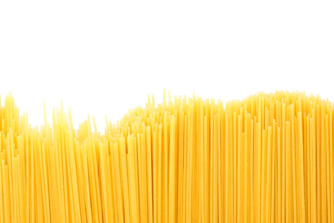 Pasta isolated on bright background. Uncooked whole wheat pasta