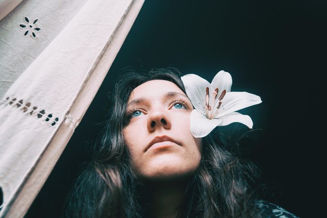 Woman lily flower on her ear