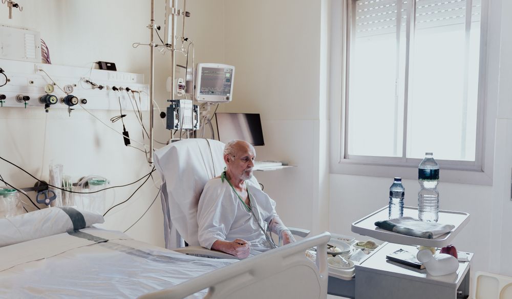 Older man admitted to a hospital room.