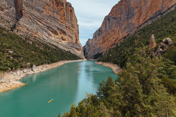 People crossing a river by kayak