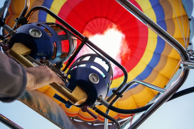 Close up of pilot switching on flame heating hot air balloon before flight