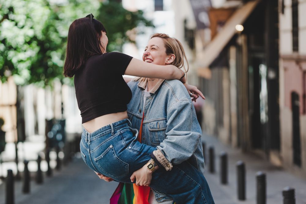 Happy lesbian couple having fun on street