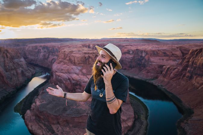 Traveler on the mobile phone near canyon