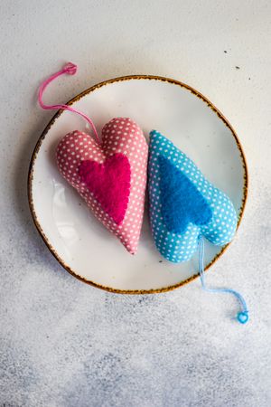 Place setting for St Valentine's Day with blue and pink felt hearts