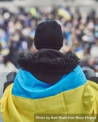 London, England, United Kingdom - March 5 2022: Back of man draped in Ukrainian flag 0JOgn5