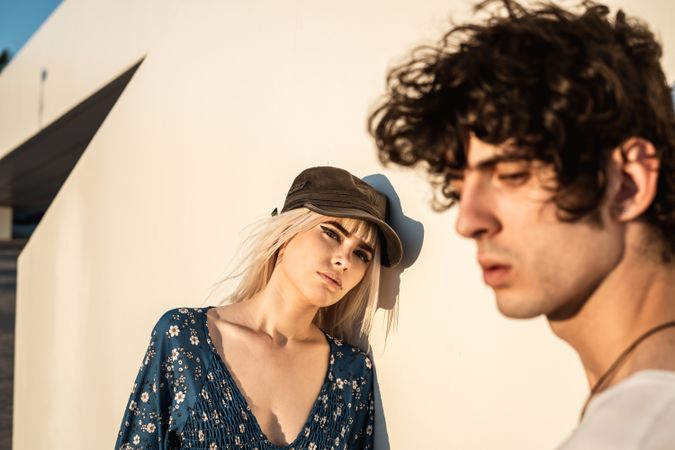 Couple leaning on wall contemplating