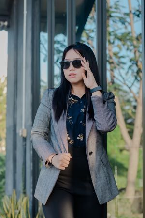 Confident young professional in tailored suit and sunglasses