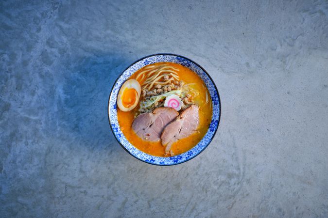 Delicious noodle soup with pork meat and egg in bowl