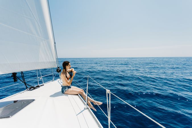 Woman in swimsuit sitting on boat