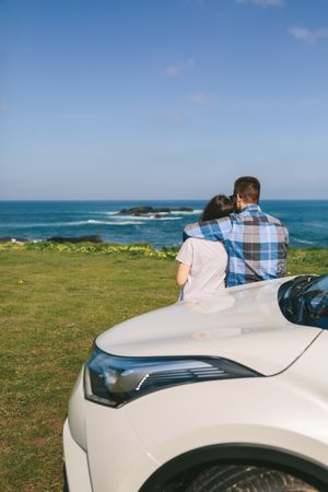Couple with car watching landscape