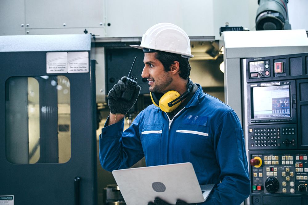 Male industrial engineer or technician in safety hard helmet