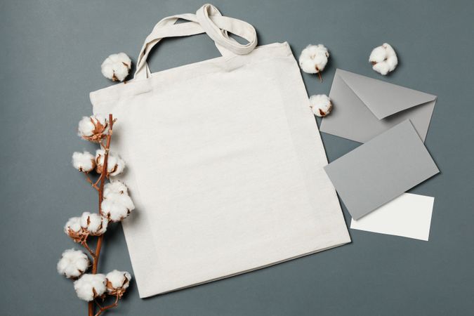 Cotton, bag and envelope on light dark background, space for text