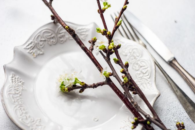 Spring table setting with cherry blossom branch on plate