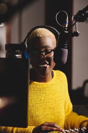 Black woman recording podcast in studio