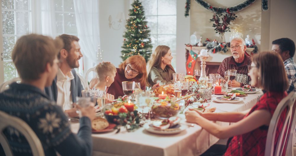 Multi-Generational Family Members Share Funny Stories and Joy During a Christmas Turkey Dinner.
