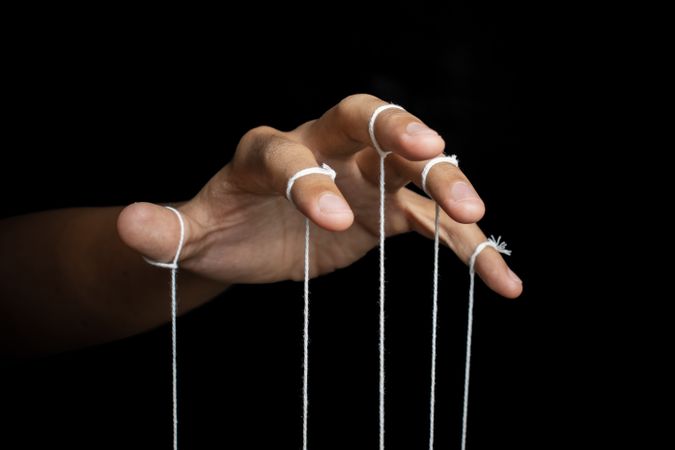 male puppeteer hand with strings