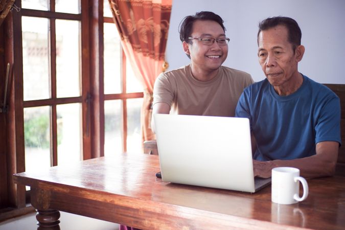 Father and son with laptop