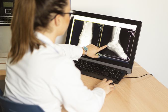 Young doctor with x-ray film document on wall