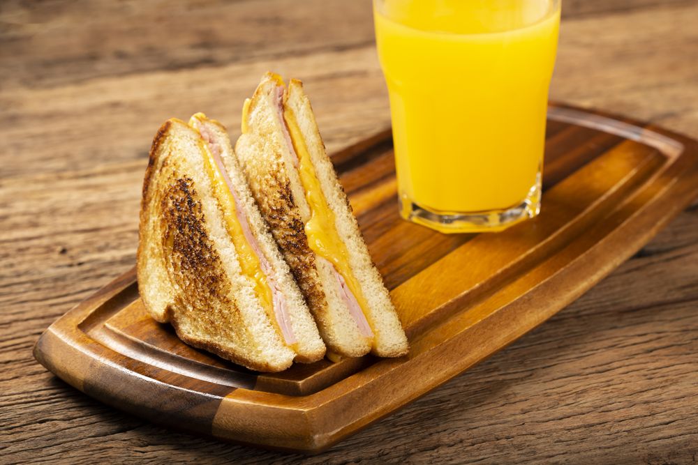 Grilled ham and cheese. Sandwich with cheese and ham on grill.