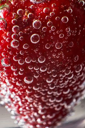 Strawberry with bubbles on glass bottom