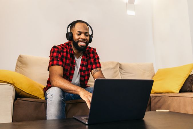 Black man making work video call with laptop at home