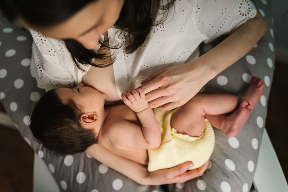 Mother feeding baby at home