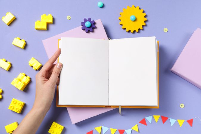 Children's book, with toys, on a purple background.