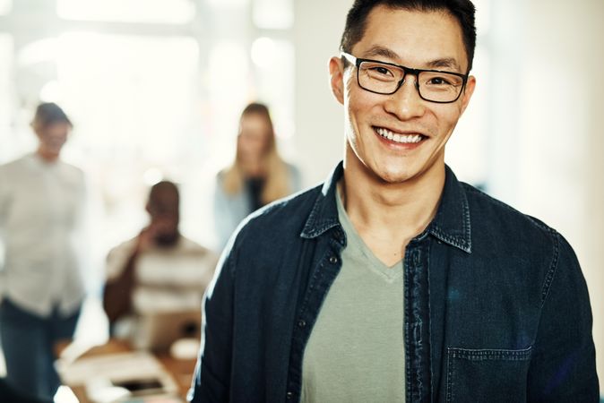 Portrait of Asian man smiling in bright office