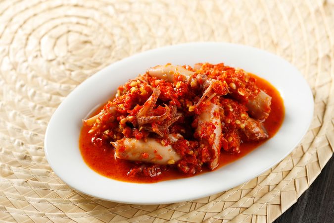 Spicy salted squid dish on placemat