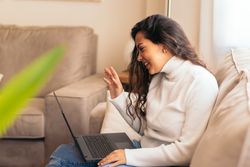 Young woman making a video call at home with a laptop