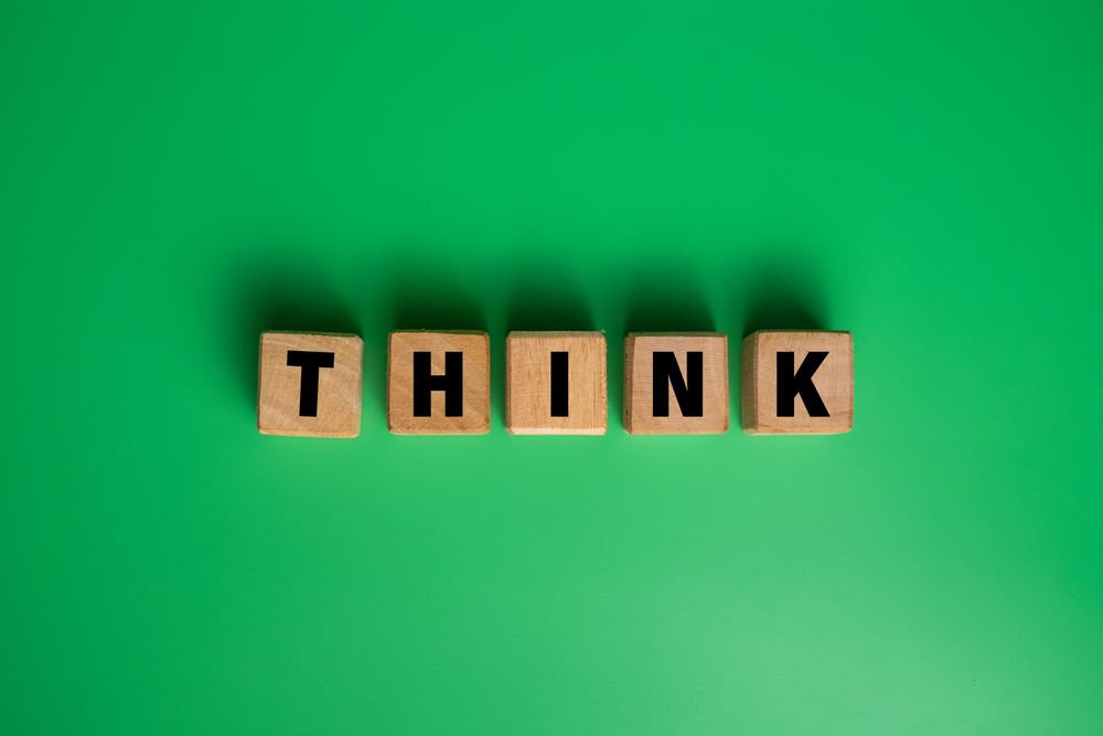 think word on wooden blocks isolated on green background