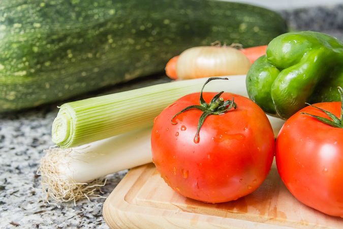 Fresh vegetables on cutting board in the kitchen