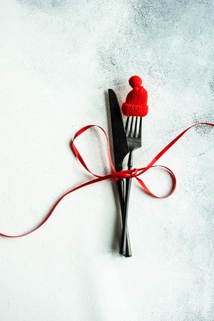 Christmas cutlery set with small red hat and ribbon