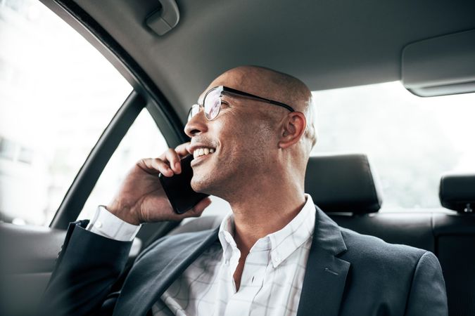 Man talking on mobile phone sitting in car