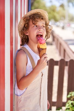 Boy eating ice cream outside