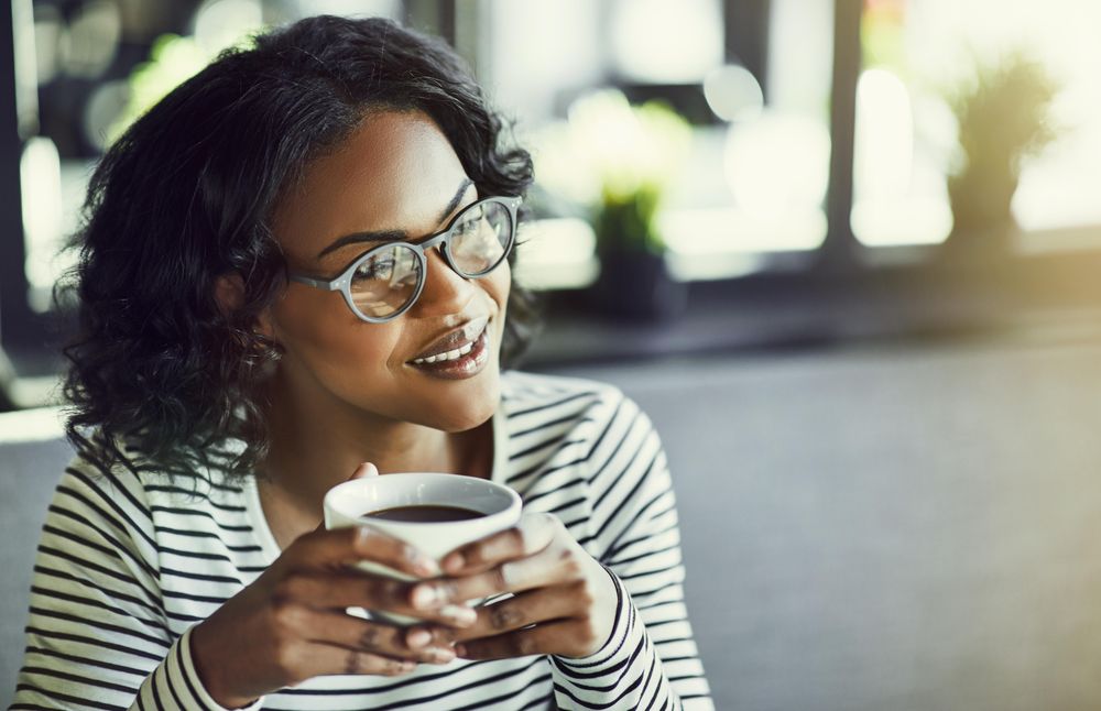 Contemplative woman relaxing with a nice cup of coffee