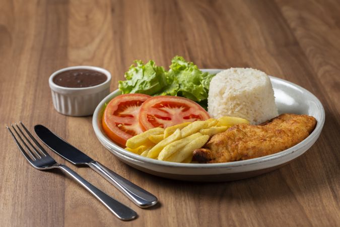 Executive dish with breaded fillet, rice, beans and salad.