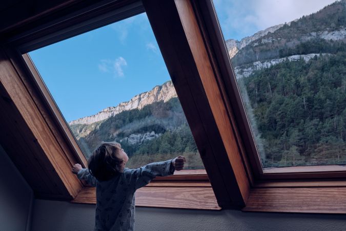 Child enjoying freedom in house in mountains