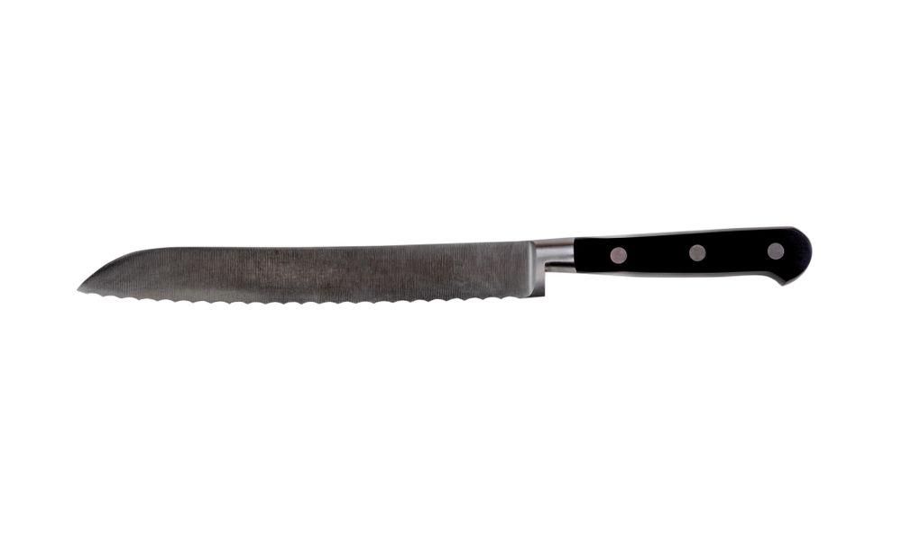 New serrated steel kitchen knife isolated on a plain background