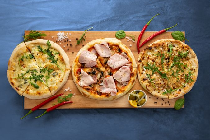 Three Pizzas on Wooden Tray