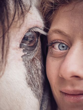 Crop woman face against horse head