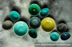 Empty colorful bowls on stone background 5XrwM7