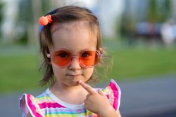 Curious toddler in sunglasses summer outdoors