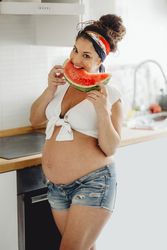 Pregnant female eating delicious watermelon